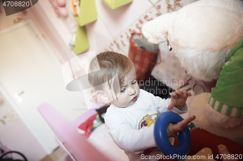 Image of cute little one year old baby and making first steps