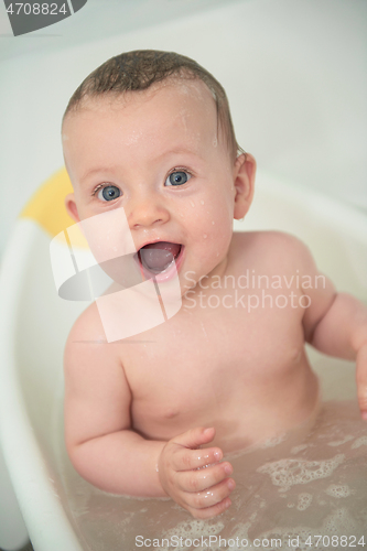 Image of cute little baby girl taking a bath