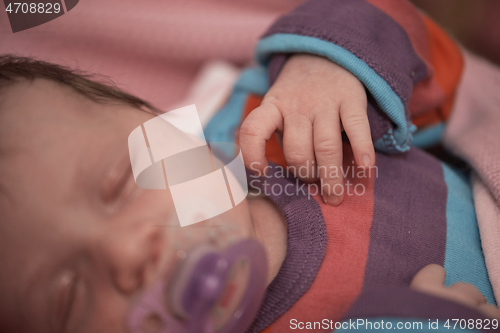 Image of One month newborn baby sleeping in bed