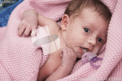 Image of One month newborn baby sleeping in bed