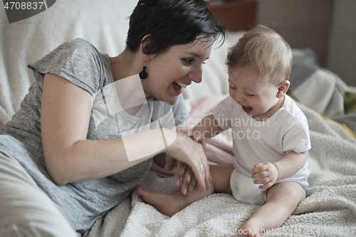 Image of mother is playing with baby at home