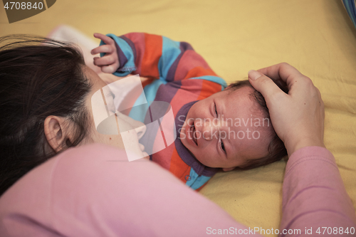 Image of mother is playing with baby at home