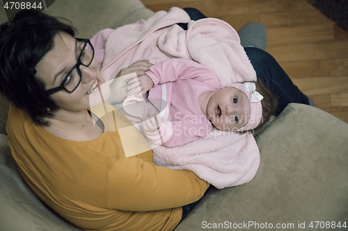 Image of mother is playing with baby at home