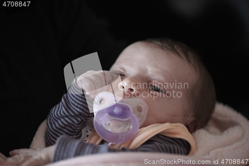 Image of One month newborn baby sleeping in bed