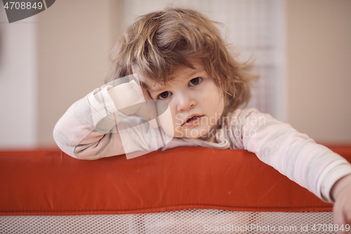 Image of little baby girl with strange hairstyle and curlers