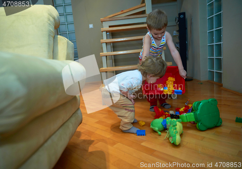 Image of Little child playing and bring toys to sister