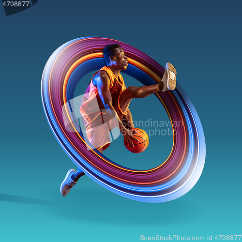 Image of Full length portrait of a basketball player with ball