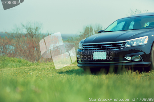 Image of View of modern black car on the river\'s side