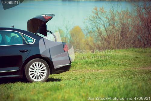 Image of View of modern black car on the river\'s side