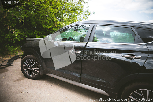 Image of Broken and crashed modern car after an accident on street