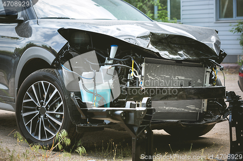 Image of Broken and crashed modern car after an accident on street