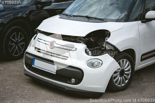 Image of Broken and crashed modern car after an accident on street