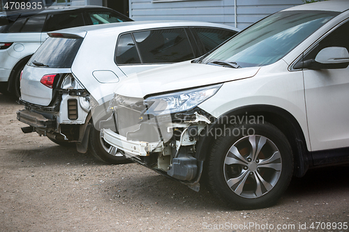 Image of Broken and crashed modern cars after an accident on street