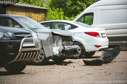 Image of Broken and crashed modern cars after an accident on street