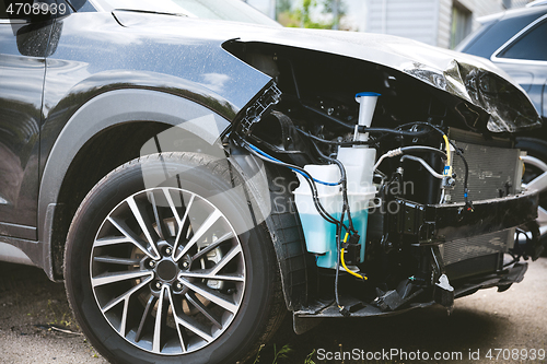 Image of Broken and crashed modern car after an accident on street