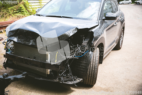 Image of Broken and crashed modern car after an accident on street