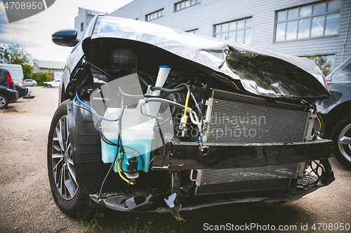 Image of Broken and crashed modern car after an accident on street