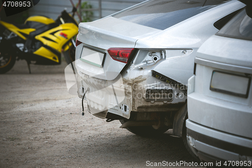 Image of Broken and crashed modern cars after an accident on street