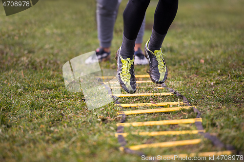 Image of american football player exercises on ladder drills