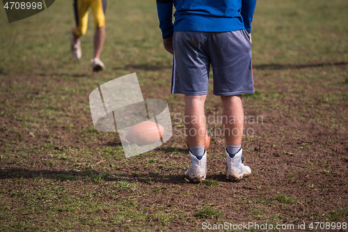 Image of american football team with coach in action