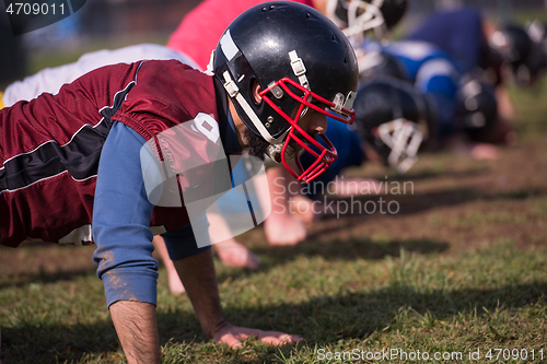 Image of american football team doing push ups