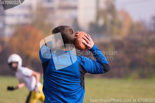 Image of american football team with coach in action