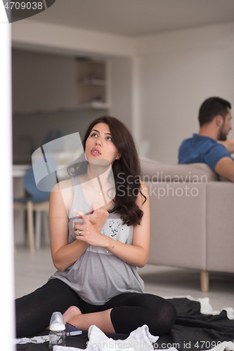 Image of pregnant couple checking a list of things for their unborn baby