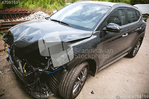 Image of Broken and crashed modern car after an accident on street