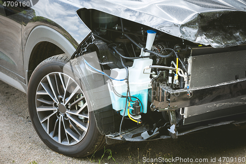 Image of Broken and crashed modern car after an accident on street