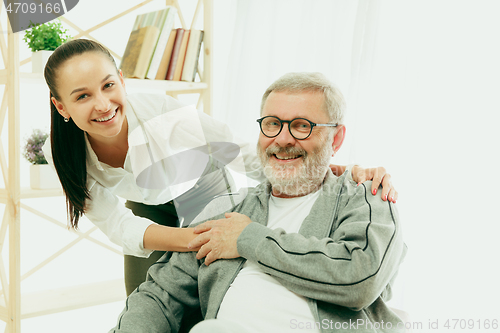 Image of A daughter or granddaughter spends time with the grandfather