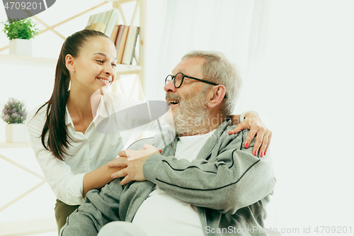 Image of A daughter or granddaughter spends time with the grandfather