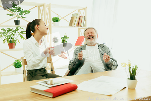 Image of A daughter or granddaughter spends time with the grandfather