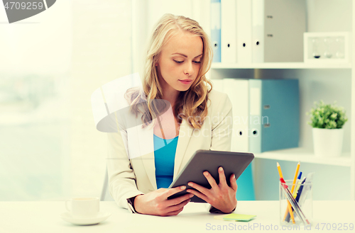 Image of businesswoman or student with tablet pc at office