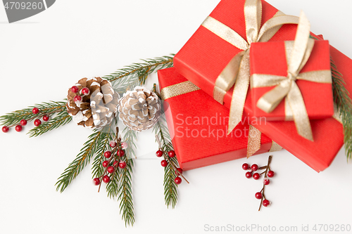 Image of christmas gifts and fir branches with pine cones