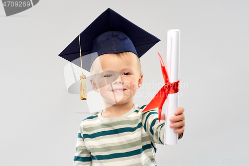 Image of smiling little boy in mortar board with diploma