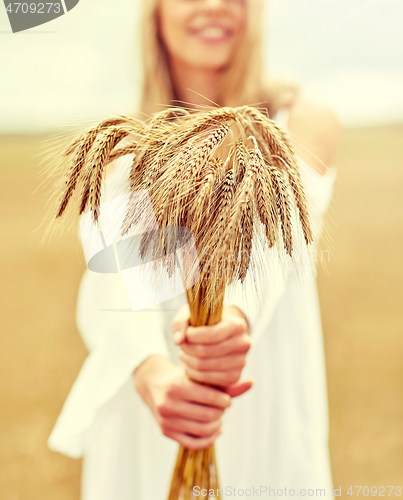 Image of close up of happy woman with cereal spikelets