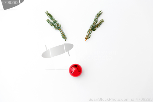 Image of christmas deer made of fir branches and red ball