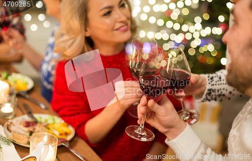 Image of close up of friends with wine celebrate christmas