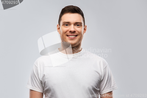 Image of portrait of smiling young man in white t-shirt