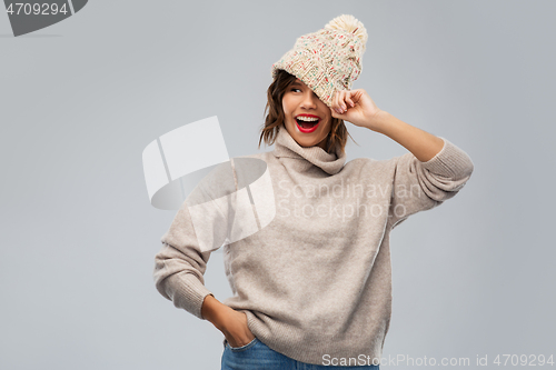 Image of young woman in knitted winter hat and sweater