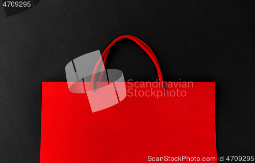 Image of red shopping bag on black background