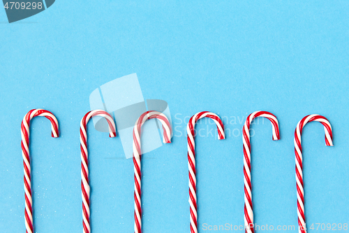 Image of candy cane decorations on blue background