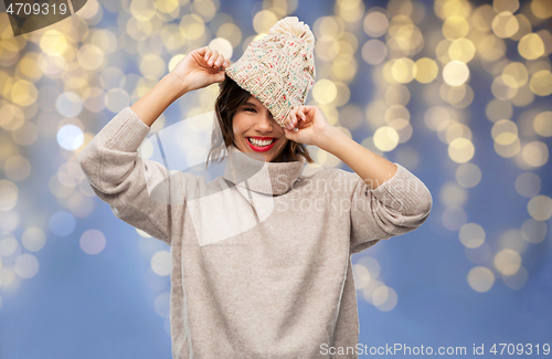 Image of young woman in winter hat and sweater on christmas