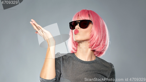 Image of woman in pink wig and sunglasses sending air kiss