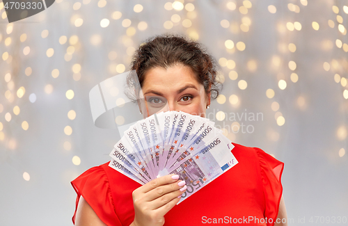 Image of happy woman holding euro money banknotes