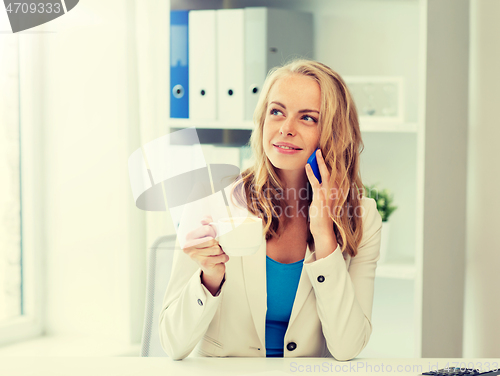 Image of businesswoman calling on smartphone at office