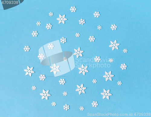 Image of white snowflake decorations on blue background