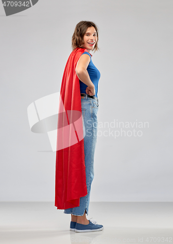 Image of happy woman in red superhero cape