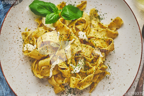 Image of Tasty tagliatelle pasta with basil and green pesto