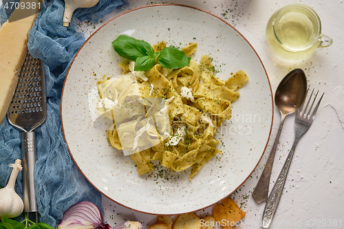Image of Tasty tagliatelle pasta with basil and green pesto